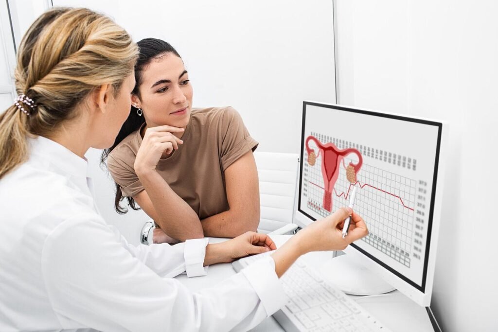 gynecologist communicates with her patient, indicating the menstrual cycle on the monitor. the reproductive specialist calculated the period of ovulation for the patient