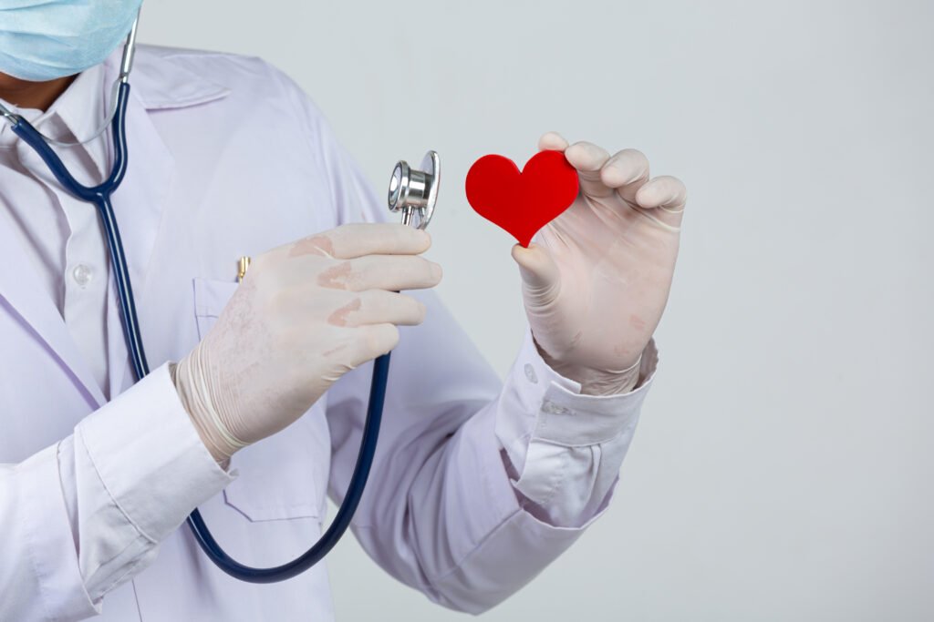 world diabetes day;docter holding stethoscope and red heart woo